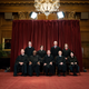 Members of the Supreme Court pose for a group photo at the Supreme Court in Washington.